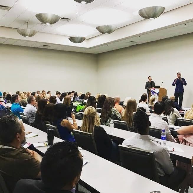 Greg teaching a room of agents