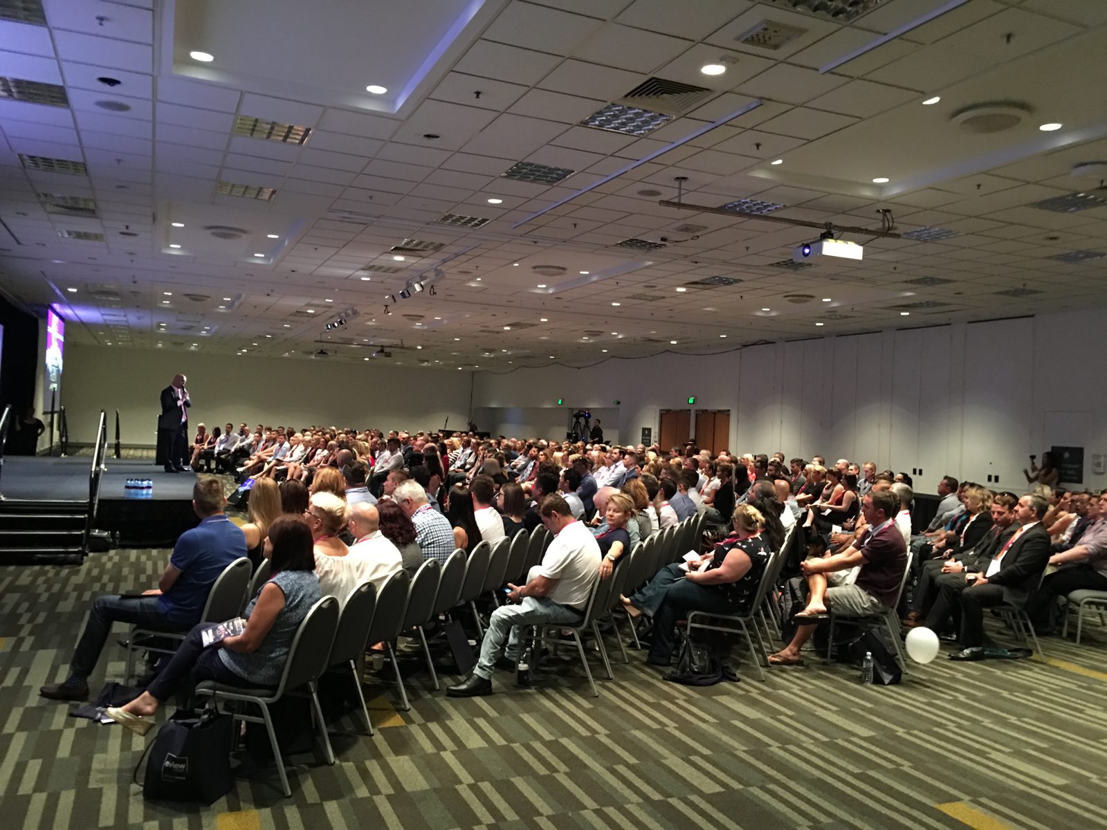 Greg speaking to a packed room at the Million Dollar Agent Summit